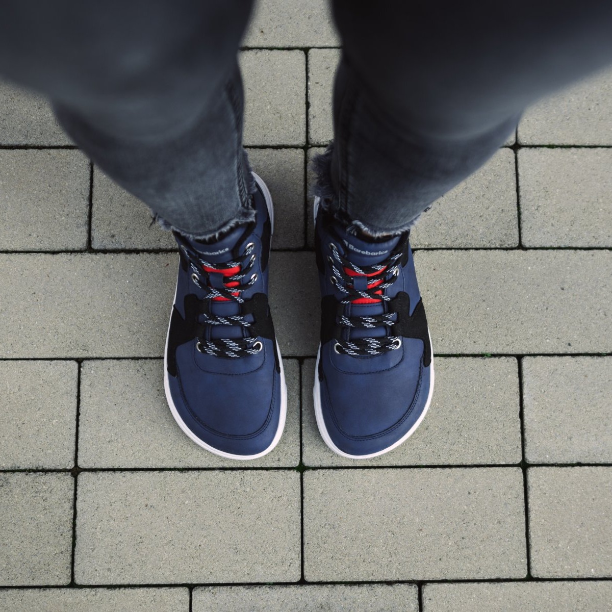 Barefoot Sneakers Barebarics Lynx - Dark Blue & White.
Les baskets Barebarics sont fabriquées selon des processus qui minimisent l'impact sur l'environnement.
La tige est composée de nubuck synthétique et de velours synthétique.La doublure est en polyester, qui est très doux et agréable au toucher, ce qui procure un confort extrême pour le talon.La semelle est en gomme synthétique souple avec une haute résistance à l'usure.La semelle ComfortGrip est conçue pour un mouvement confortable et la découverte de nouveaux endroits, pas seulement dans le milieu urbain.La semelle intérieure est amovible et composée de PU recyclé et de microfibres, qui assurent une excellente respirabilité et aident à garder les pieds au sec.

Attributs barefoot
Forme anatomique - Les basket respectent la forme du pied.
Plus d'information
design urbain moderneconçu et fabriqué à la main dans l’Union européenne, à partir de matériaux durables locauxexcellente durabilité et solidité des couleurs des matériauxTechnologie Dermodry Coolmax® pour une élimination continue de l’humiditédisponible en numéros : 36 - 47 (selon mesure européenne)chaussure de ville